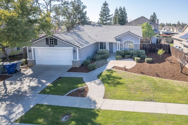 single story home featuring concrete driveway, stone siding, a tiled roof, fence, and a front yard