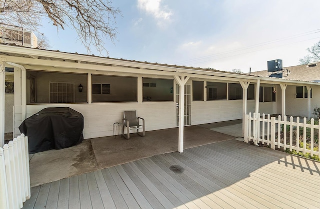 deck featuring central air condition unit, a grill, and fence