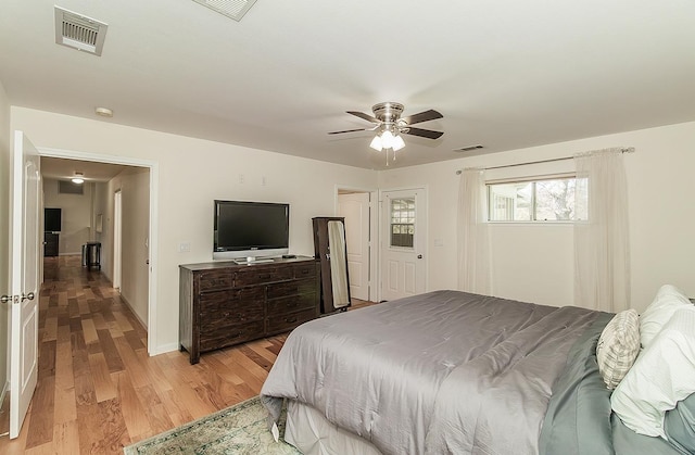 bedroom with visible vents, ceiling fan, and light wood-style flooring