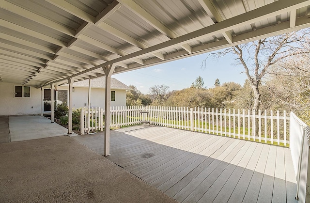 wooden terrace with fence and a patio