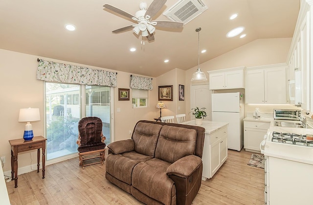 kitchen with white appliances, visible vents, white cabinets, open floor plan, and light countertops