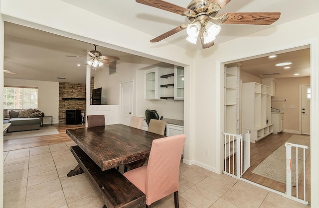 29039 Auberry Rd, Prather, CA 93651 - dining space with ceiling fan, light tile patterned floors, a stone fireplace, recessed lighting, and vaulted ceiling