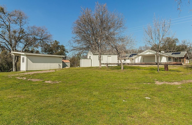 29039 Auberry Rd, Prather, CA 93651 - view of grassy yard with an attached garage and an outbuilding