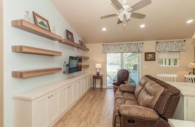 living room with a ceiling fan, recessed lighting, vaulted ceiling, and light wood finished floors