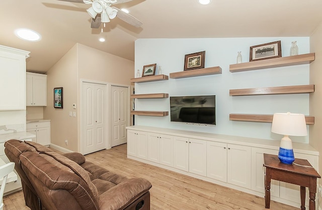 living room with ceiling fan, recessed lighting, baseboards, vaulted ceiling, and light wood finished floors