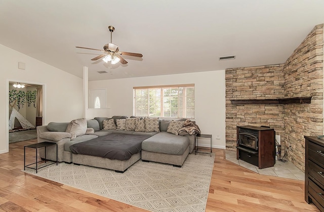 living area with visible vents, vaulted ceiling, light wood finished floors, and ceiling fan