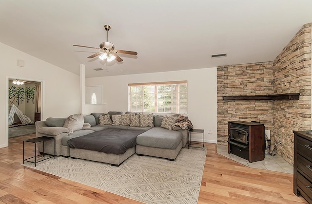 29039 Auberry Rd, Prather, CA 93651 - living area featuring lofted ceiling, a wood stove, a ceiling fan, and light wood finished floors