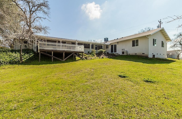 rear view of house featuring a deck, a yard, central AC unit, and crawl space