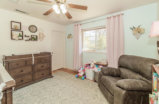 interior space featuring visible vents and a ceiling fan