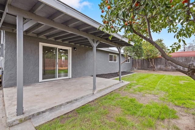 view of yard featuring fence and a patio