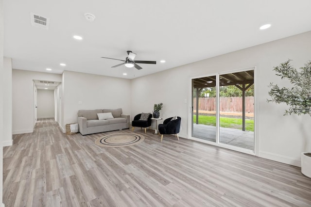 living area with a ceiling fan, recessed lighting, visible vents, and wood finished floors