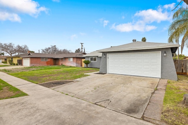 ranch-style house with a garage, driveway, a front lawn, and stucco siding