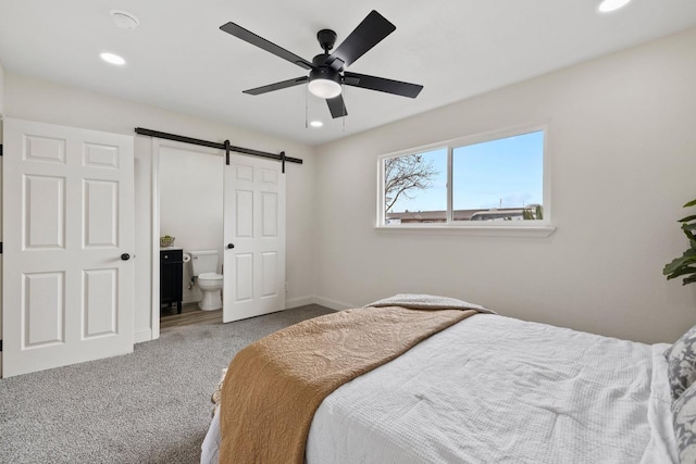 carpeted bedroom with a ceiling fan, recessed lighting, baseboards, and a barn door