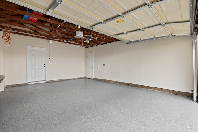 garage with a garage door opener and baseboards