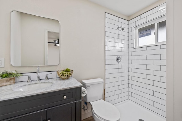 full bathroom with a stall shower, vanity, and toilet