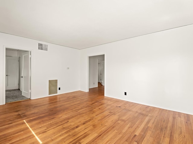 empty room with visible vents and light wood finished floors