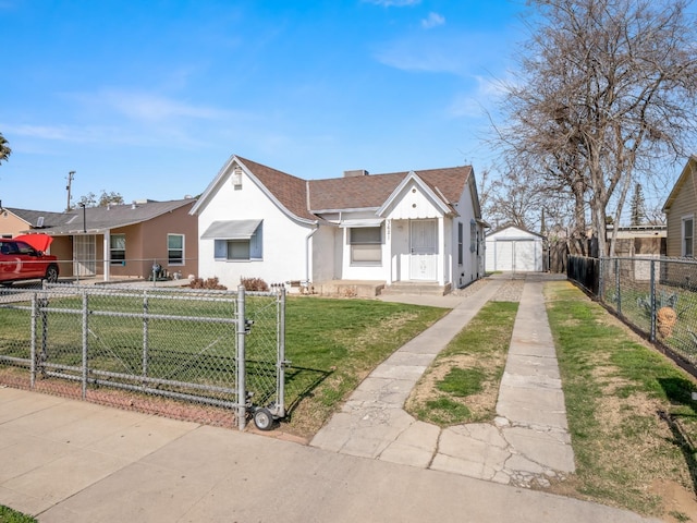 bungalow featuring a fenced front yard, a gate, driveway, and a front lawn