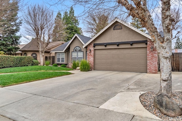 ranch-style home featuring brick siding, stucco siding, a front yard, a garage, and driveway