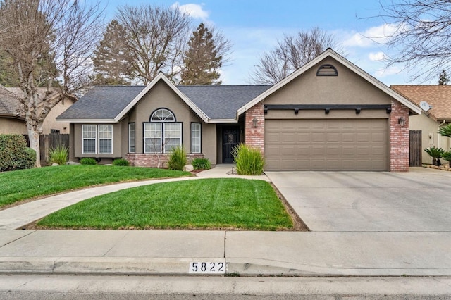 ranch-style home featuring brick siding, an attached garage, and stucco siding