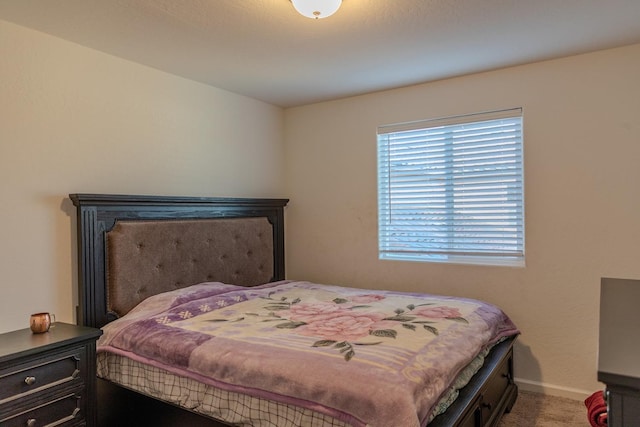 carpeted bedroom featuring baseboards