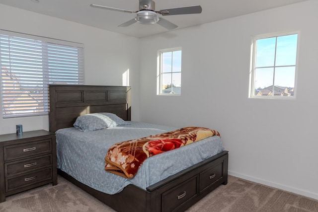 bedroom with ceiling fan, baseboards, and carpet flooring