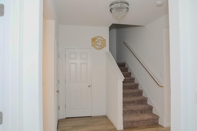 staircase with wood finished floors and baseboards