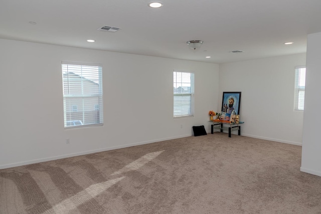 unfurnished room with baseboards, carpet flooring, visible vents, and recessed lighting