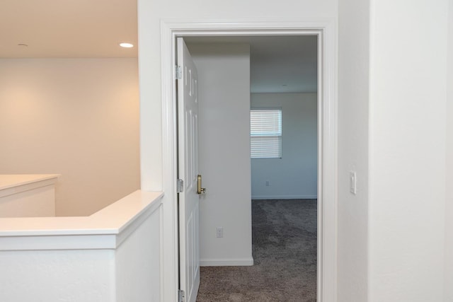 corridor featuring carpet floors, baseboards, and recessed lighting