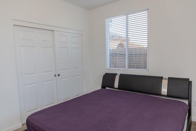 unfurnished bedroom with carpet, baseboards, and a closet