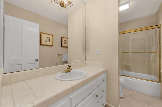 full bathroom with toilet, tile patterned flooring, bath / shower combo with glass door, and vanity