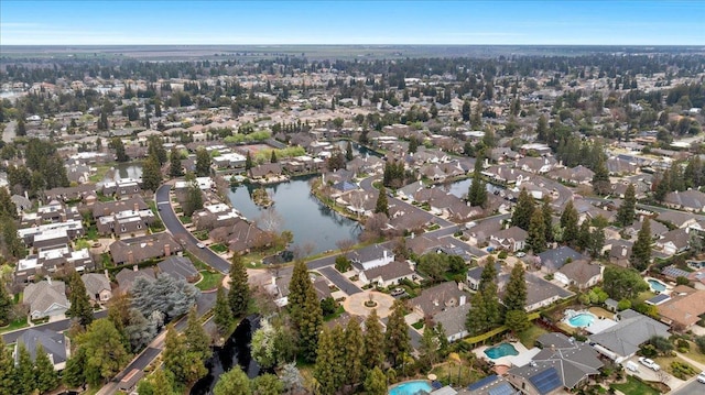 drone / aerial view with a water view and a residential view