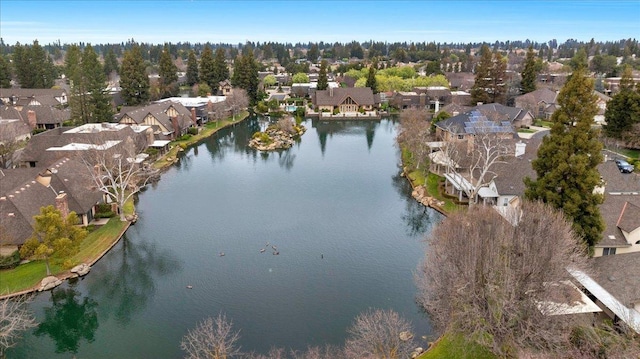 drone / aerial view featuring a water view and a residential view