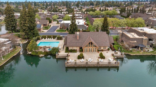 birds eye view of property with a residential view and a water view