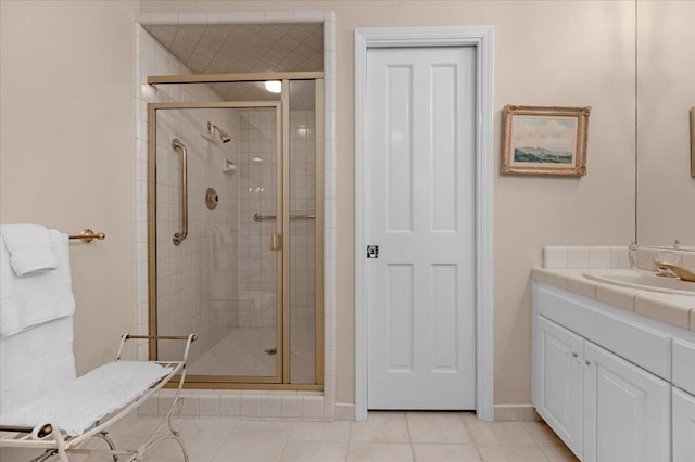 bathroom featuring baseboards, a shower stall, vanity, and tile patterned floors