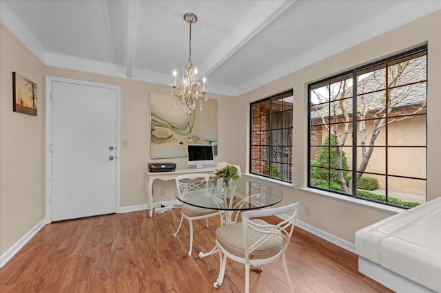 dining area featuring beamed ceiling, wood finished floors, and baseboards