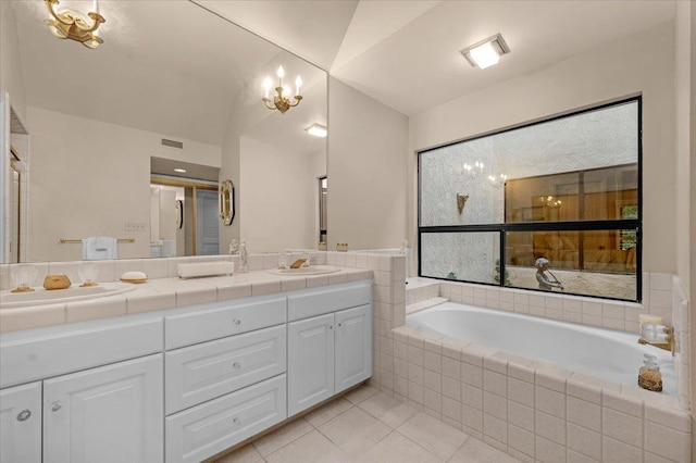 full bathroom featuring a garden tub, a sink, visible vents, tile patterned floors, and double vanity