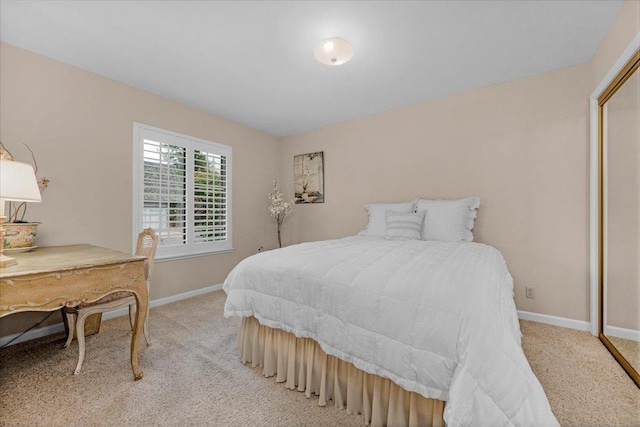 bedroom with light carpet and baseboards