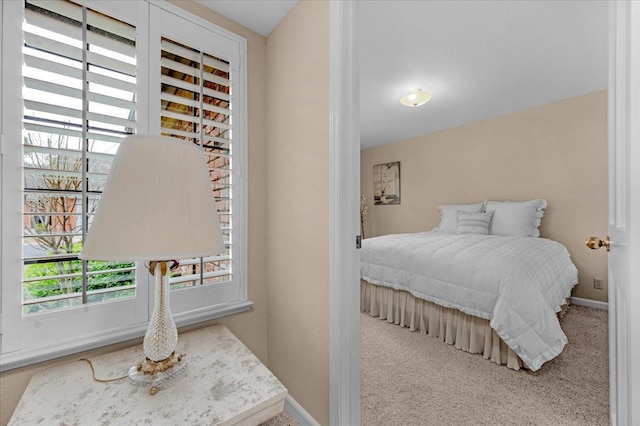 bedroom with carpet and baseboards