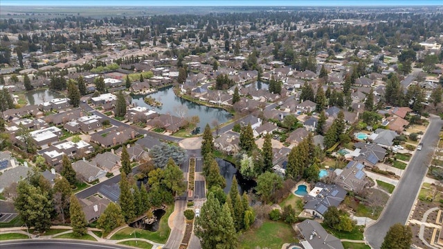 birds eye view of property with a water view and a residential view