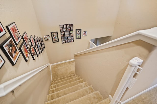 staircase with carpet and baseboards