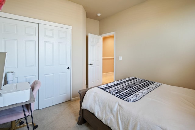 bedroom with a closet and light carpet