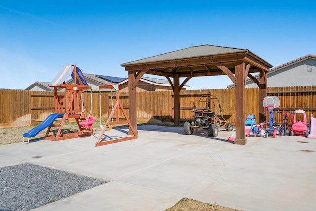 view of patio / terrace featuring a fenced backyard, a playground, and a gazebo