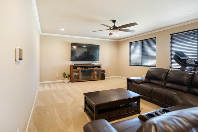 living area with crown molding, ceiling fan, baseboards, and light colored carpet