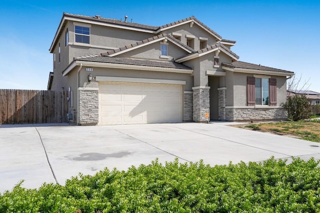 view of front of house featuring stone siding, fence, driveway, and stucco siding