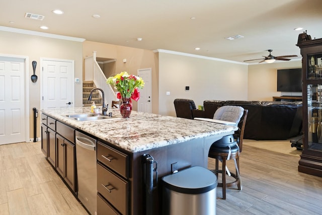 kitchen with light wood-style floors, recessed lighting, a sink, and ornamental molding