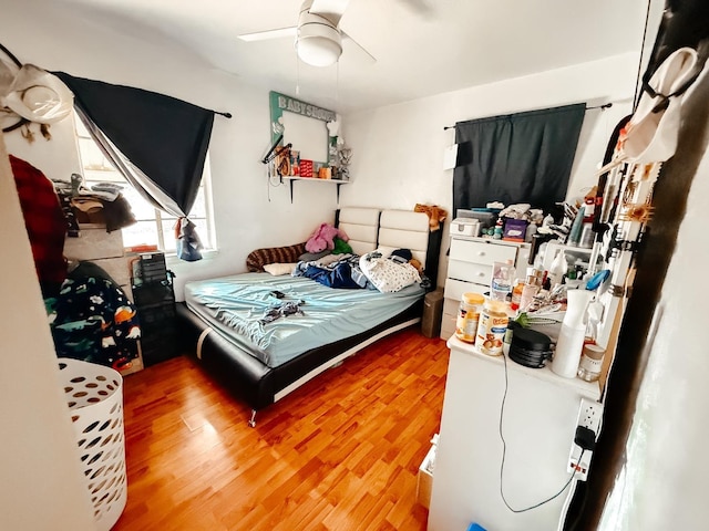 bedroom featuring ceiling fan and wood finished floors