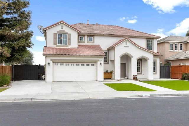 mediterranean / spanish home with a garage, driveway, a tiled roof, a gate, and fence