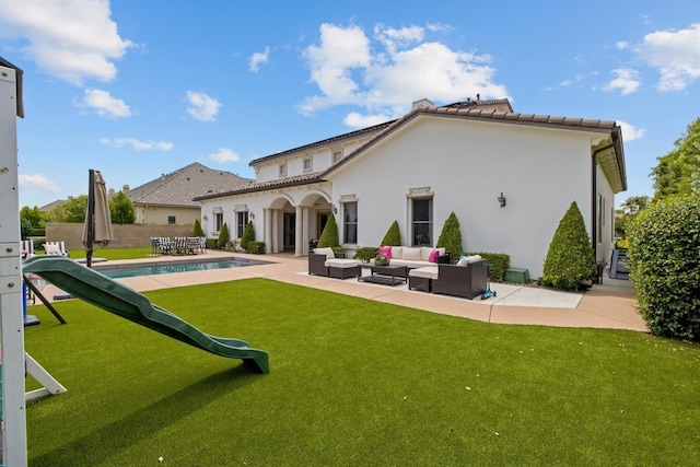 back of house with a fenced in pool, a lawn, a patio, an outdoor living space, and stucco siding