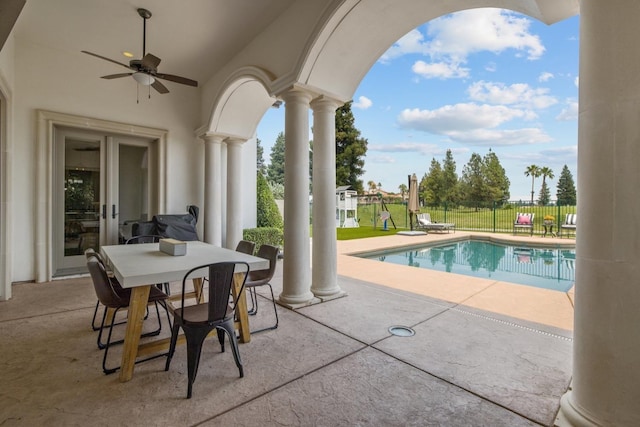 view of swimming pool featuring a fenced in pool, a yard, a patio, a ceiling fan, and fence