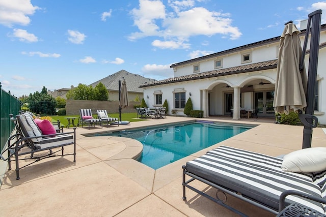 view of pool with a ceiling fan, a fenced in pool, a patio, fence, and french doors